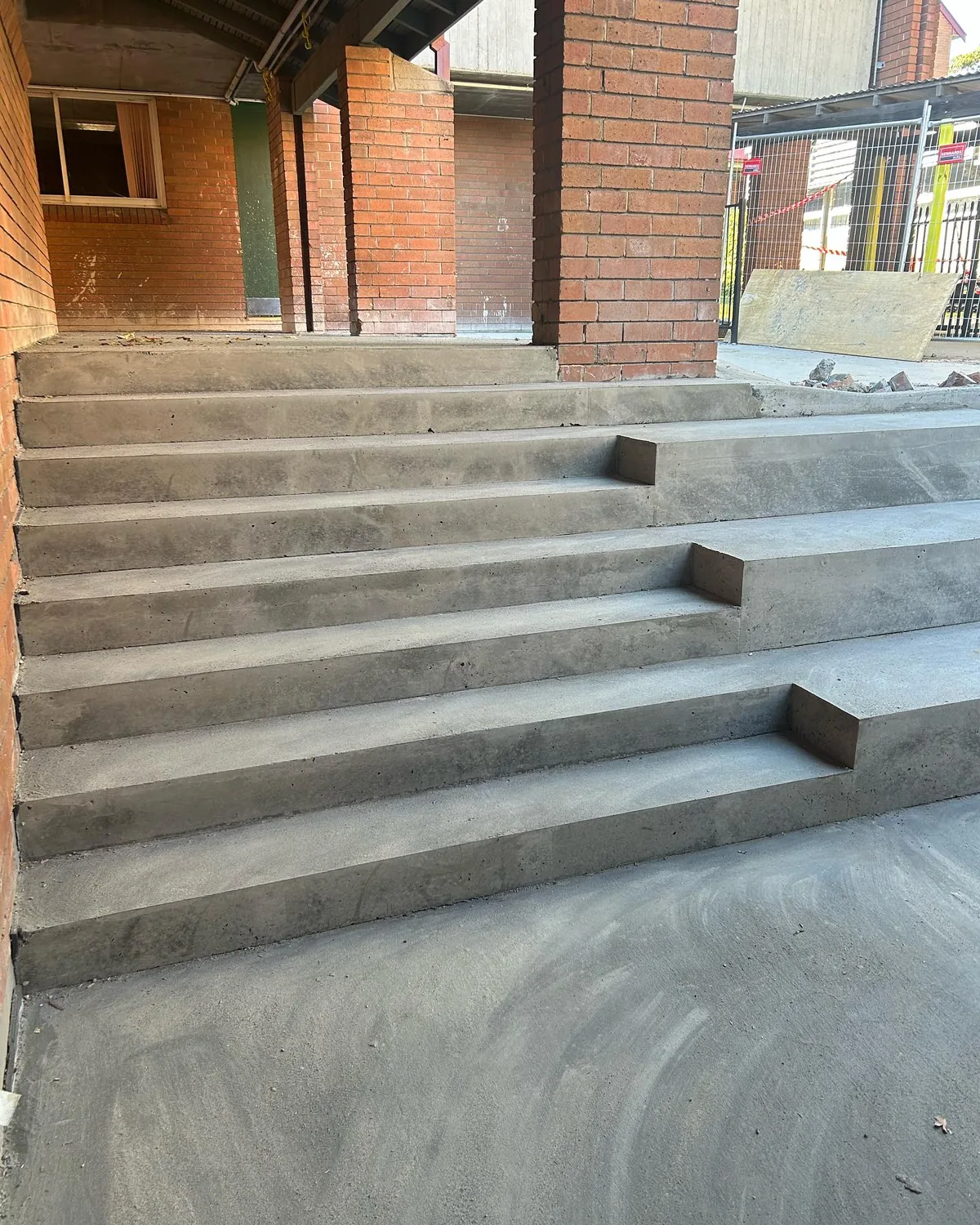 Concrete stairs against brick wall